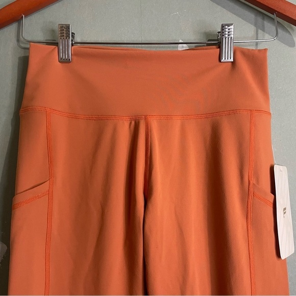 NWT Fabletics High Waisted Side Pocket 7/8 Leggings in Rust Orange - Picture 2 of 6
